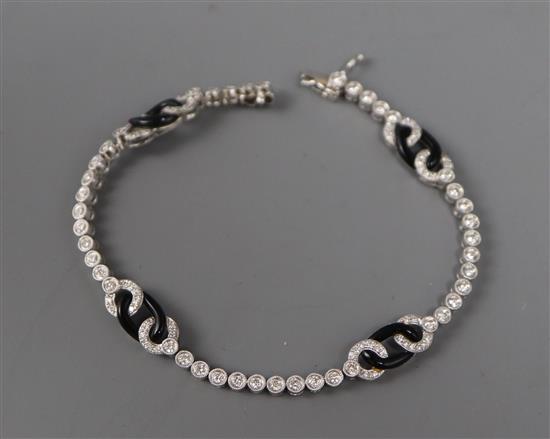 A modern 1920s style 18ct white gold and black onyx line bracelet, 17.3cm.